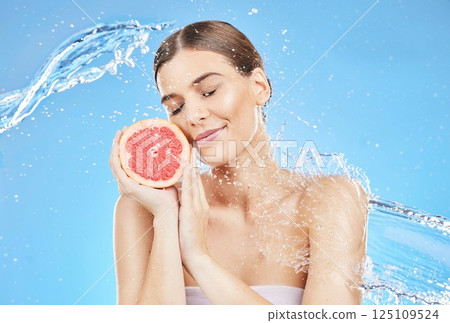 Woman, splash and fruit with water for shower, skincare and bodycare for health and wellness on a blue studio background. Beauty, wash and hydration with grapefruit or vitamin c for cosmetic cleanse Woman, splash and fruit with water for shower, skincare and bodycare for health and wellness on a blue studio background. Beauty, wash and hydration with grapefruit or vitamin c for cosmetic cleanse 125109524