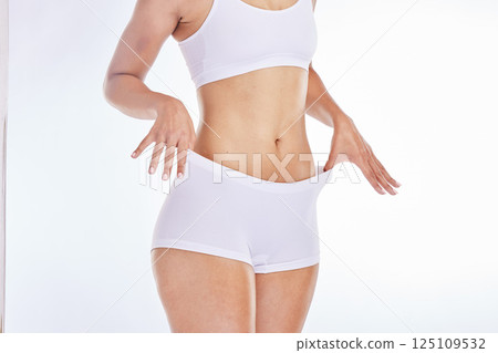 Beauty, weightloss and slim body of woman isolated on white background in studio for healthy lifestyle. Wellness, fitness and female model in white underwear for dieting, nutrition and body care 125109532