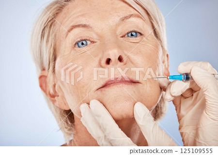 Botox, senior woman and injection for health, smooth skin and wellness with grey studio background. Plastic surgery, mature female or elderly lady with fine needle, body care facial detox or skincare 125109555