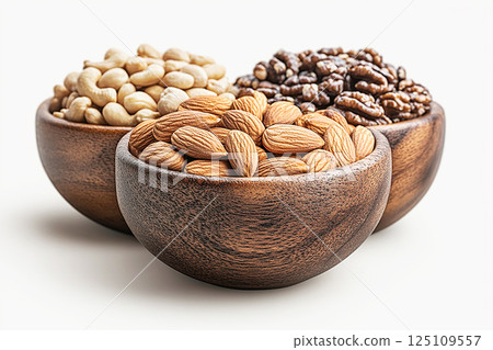 Healthy mix of almonds, walnuts, and cashews in a bowls. Healthy mix of almonds, walnuts, and cashews in a bowls. 125109557