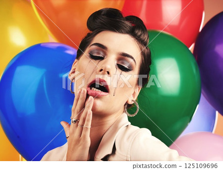Woman, balloon and sad cry in studio with makeup tears, depression or anxiety at birthday. Mental health model, party or depressed by balloons, frustrated mascara crying or moody with stress at event 125109696
