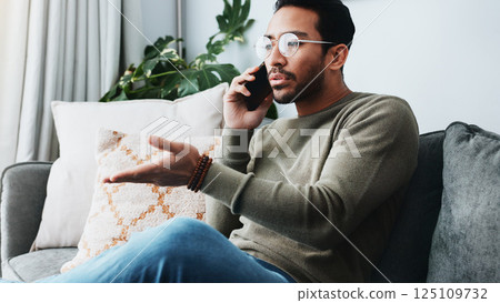 Phone call, frustrated and man on sofa in home for client feedback with freelance job. Cellphone, remote work and male person on mobile discussion with negative review for bad service in house. Phone call, frustrated and man on sofa in home for client feedback with freelance job. Cellphone, remote work and male person on mobile discussion with negative review for bad service in house. 125109732