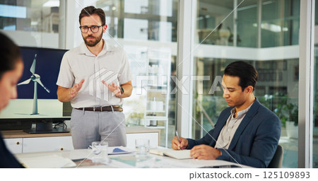 Businessman, meeting or presentation with discussion for renewable or clean energy at conference. Man, employee or speaker talking to group with proposal for wind turbine or eco development at office Businessman, meeting or presentation with discussion for renewable or clean energy at conference. Man, employee or speaker talking to group with proposal for wind turbine or eco development at office 125109893