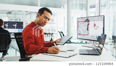 Computer screen, wind turbine and writing with business man in office for renewable energy or sustainability. Electricity, tablet and windmill with map on display for development or engineering 125109964
