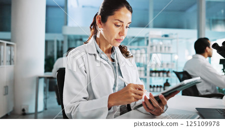 Scientist, woman and medical research with tablet at lab with writing, review and notes for pharma job. Person, gloves and equipment with application for vaccine development, trial and clinical study 125109978