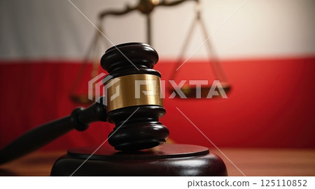 Judge's gavel, justice scales, Polish flag behind 125110852