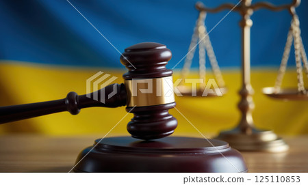 Judge's gavel, justice scales, Ukrainian flag behind Judge's gavel, justice scales, Ukrainian flag behind 125110853