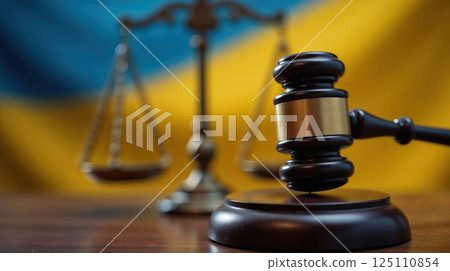 Legal symbols of justice in front of the Ukrainian flag Legal symbols of justice in front of the Ukrainian flag 125110854