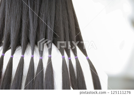 Hair tied up for hair donation 125111276