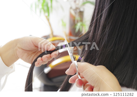 A woman cutting hair for hair donation A woman cutting hair for hair donation 125111282