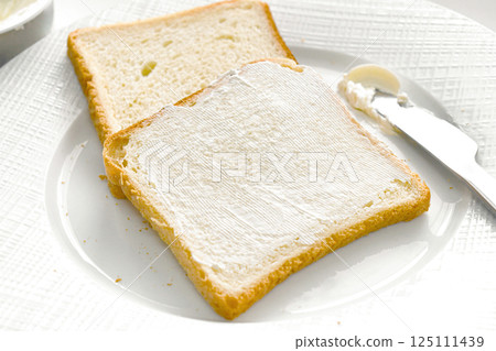 Bread slices with cream cheese on a plate. Bread slices with cream cheese on a plate. 125111439