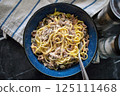 Spathetti sardine with fork in a bowl. Pasta sardines on fork. Traditional healthy Italian food. 125111468