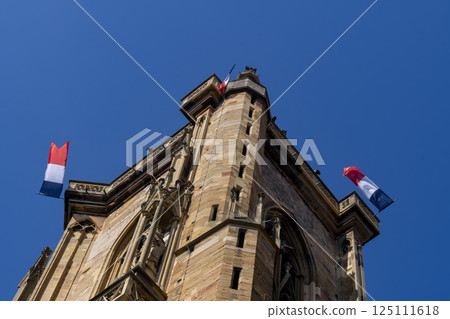 French tricolour flags flying on historic building in Colmar, France 125111618