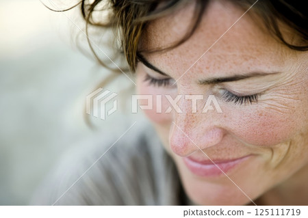A potrait of middle aged woman looking naturally, wreckles on face A potrait of middle aged woman looking naturally, wreckles on face 125111719