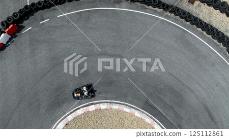 Aerial view go kart racer race curve circuit, Go kart at circuit curve, Top view race go kart track curve. Aerial view go kart racer race curve circuit, Go kart at circuit curve, Top view race go kart track curve. 125112861