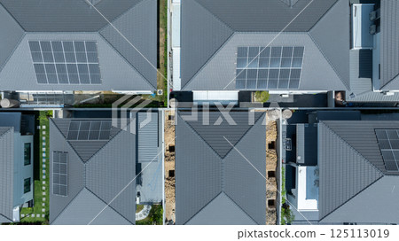 Solar panels being installed on home building rooftop, Solar panels installed on new houses being built, Sustainable homes with solar panel rooftop being built, Aerial view 125113019