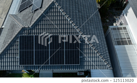 Solar panels being installed on home building rooftop, Solar panels installed on new houses being built, Sustainable homes with solar panel rooftop being built, Aerial view 125113020