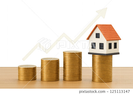 Growth of Real Estate Investment Illustrated With Coins and Miniature House Model 125113147