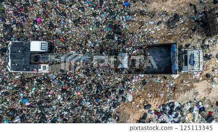 Garbage dump pile in trash dump or landfill, Landfill with waste disposal, Garbage truck unloads rubbish in landfill, Truck waste dump waste from household, Excavator work garbage waste, Aerial view. Garbage dump pile in trash dump or landfill, Landfill with waste disposal, Garbage truck unloads rubbish in landfill, Truck waste dump waste from household, Excavator work garbage waste, Aerial view. 125113345
