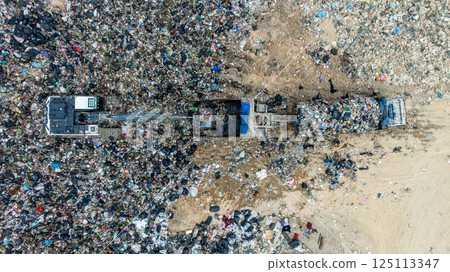 Garbage dump pile in trash dump or landfill, Landfill with waste disposal, Garbage truck unloads rubbish in landfill, Truck waste dump waste from household, Excavator work garbage waste, Aerial view. Garbage dump pile in trash dump or landfill, Landfill with waste disposal, Garbage truck unloads rubbish in landfill, Truck waste dump waste from household, Excavator work garbage waste, Aerial view. 125113347