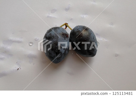 A delicious two plums with drop water. 125113481