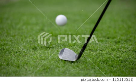 Golf club chip golf ball onto the green, Golf ball on rough chipping golf ball onto the green with golf club, Play golf ball from rough. Golf club chip golf ball onto the green, Golf ball on rough chipping golf ball onto the green with golf club, Play golf ball from rough. 125113538