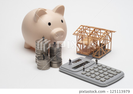 A model of a house under construction and an image of a mortgage 125113979