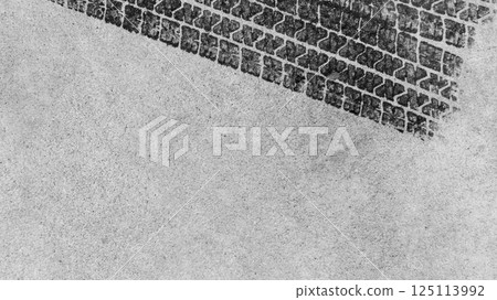 Black tire marks on road, Black rubber tire marks and tread marks, Tire trace track wheels texture and background, Auto tire tread grunge, Car wheel tyre tread track black tyre print, Top view. 125113992