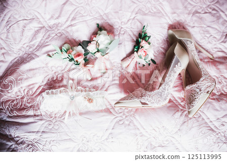 White stylish wedding shoes for bride. Close-up White stylish wedding shoes for bride. Close-up 125113995