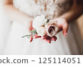 Bride holding big and beautiful wedding bouquet with flowers 125114051