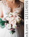 Bride holding big and beautiful wedding bouquet with flowers 125114056