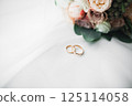 Two golden wedding rings isolated background concept 125114058