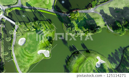 Top view golf course with lush greens, green fairway and sand bunker, Golf course green grass and trees fairway and putting green, Beautiful golf course. Top view golf course with lush greens, green fairway and sand bunker, Golf course green grass and trees fairway and putting green, Beautiful golf course. 125114271