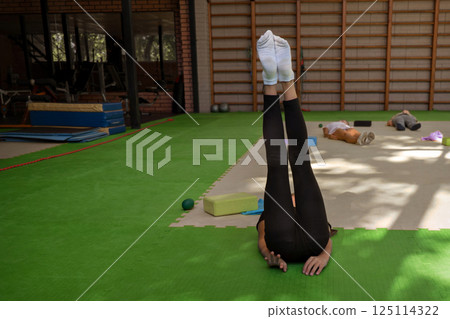 Training of children in the gym. Gymnastics, circus, fitness for girls. High quality photo 125114322