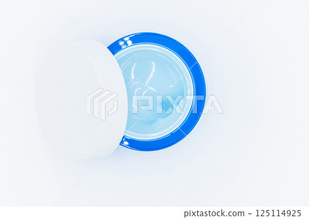 Top view blue water gel cosmetic serum in blue container, Liquid gel moisturizer, Blue gel serum texture make up and cosmetic texture background, skincare product and beauty cream. 125114925