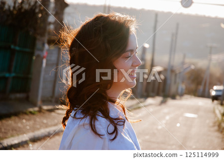 Serene outdoor stroll with smiling woman in morning sunlight Serene outdoor stroll with smiling woman in morning sunlight 125114999