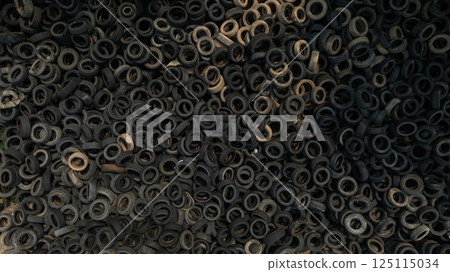 Top view Industrial landfill waste tires and rubber tyres,  Pile of old tires and wheels for rubber recycling, Used car tires pile in the tire repair shop yard, Old tires trash storage, Used tires 125115034