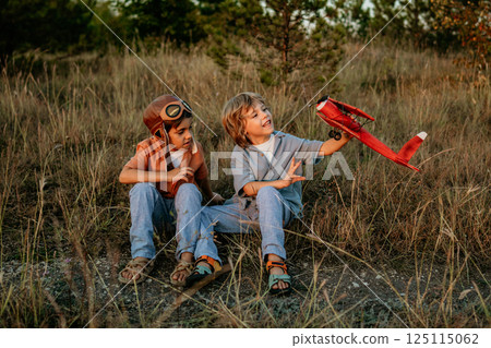 Preschool children boys playing, aviation,craft wooden retro styled airplane toy Preschool children boys playing, aviation,craft wooden retro styled airplane toy 125115062
