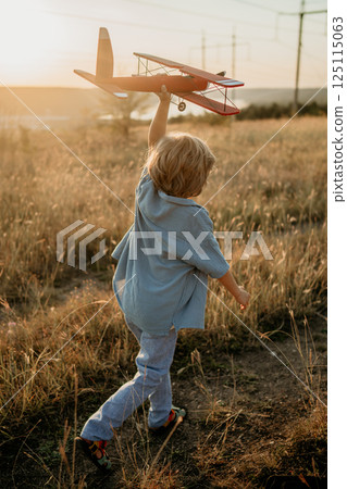 Happy handsome 5 Years Old Child Boy Running With Wooden Vintage Airplane. Kid 125115063