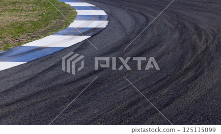 Tire mark on curve race track, Abstract black tire mark on race track, Abstract background black tire mark skid on asphalt road racing circuit, Tire track on curve road race speed track circuit. Tire mark on curve race track, Abstract black tire mark on race track, Abstract background black tire mark skid on asphalt road racing circuit, Tire track on curve road race speed track circuit. 125115099