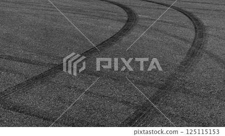 Car tire mark burnout on asphalt road race track, Abstract car tire mark from car on the asphalt road, Tire mark on race track texture and background, Black tire track skid mark on asphalt road. 125115153