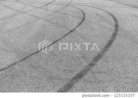 Car tire mark burnout on asphalt road race track, Abstract car tire mark from car on the asphalt road, Tire mark on race track texture and background, Black tire track skid mark on asphalt road. Car tire mark burnout on asphalt road race track, Abstract car tire mark from car on the asphalt road, Tire mark on race track texture and background, Black tire track skid mark on asphalt road. 125115157
