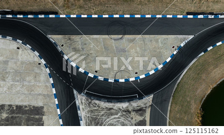 Asphalt race track with tire mark, Race track for auto racing with car tire skid mark, Car race track asphalt track circuit, Empty curve racetrack car tire mark. 125115162