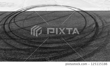 Black car tire marks on asphalt car race track circuit, Car tire mark on speed track texture and background, Abstract car tire mark on race track, Top view car tire track. 125115186