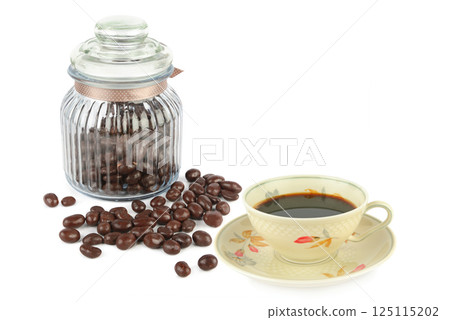 Chocolate dragees in a glass jar and Coffee in vintage porcelain cup isolated on white background. Chocolate dragees in a glass jar and Coffee in vintage porcelain cup isolated on white background. 125115202