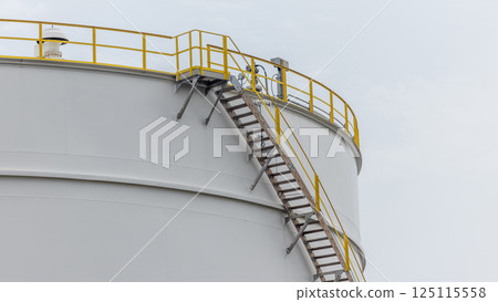 White oil storage tank with blue sky background at oil and gas refinery industrial zone, Business industrial factory oil and gas refinery, Crude oil and gas storage tank business logistic and 125115558