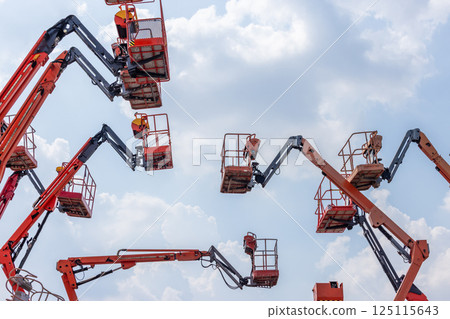 Articulate boom lift with blue sky background, Aerial platform lift telescopic boom lift hydraulic boom lift, Mobile construction crane, Construction boom lifts Articulate boom lift with blue sky background, Aerial platform lift telescopic boom lift hydraulic boom lift, Mobile construction crane, Construction boom lifts 125115643