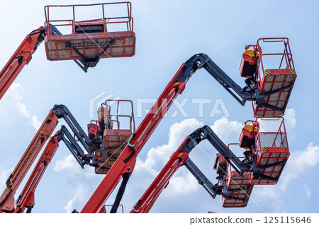 Articulate boom lift with blue sky background, Aerial platform lift telescopic boom lift hydraulic boom lift, Mobile construction crane, Construction boom lifts 125115646