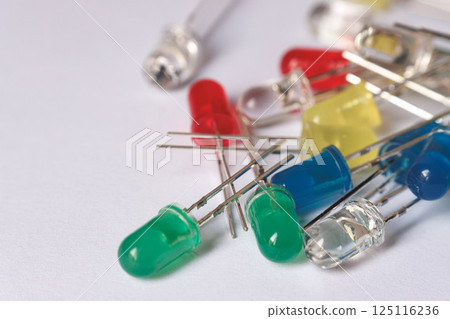 Colorful LED diodes scattered on white background Colorful LED diodes scattered on white background 125116236