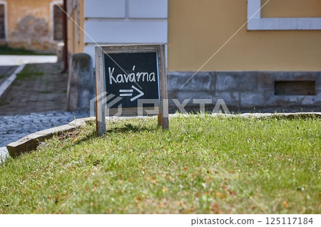Signboard for a cafe showing direction on the street Signboard for a cafe showing direction on the street 125117184